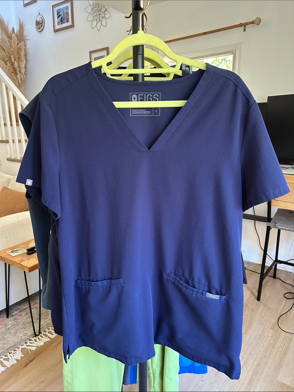 Figs Casma Three-Pocket Scrub Top. Size large. Small mark below left pocket
